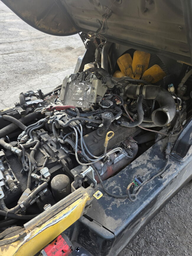 Engine tune up in progress on a Hyster S120FT-BCS forklift showing the radiator fan, intake and exhaust